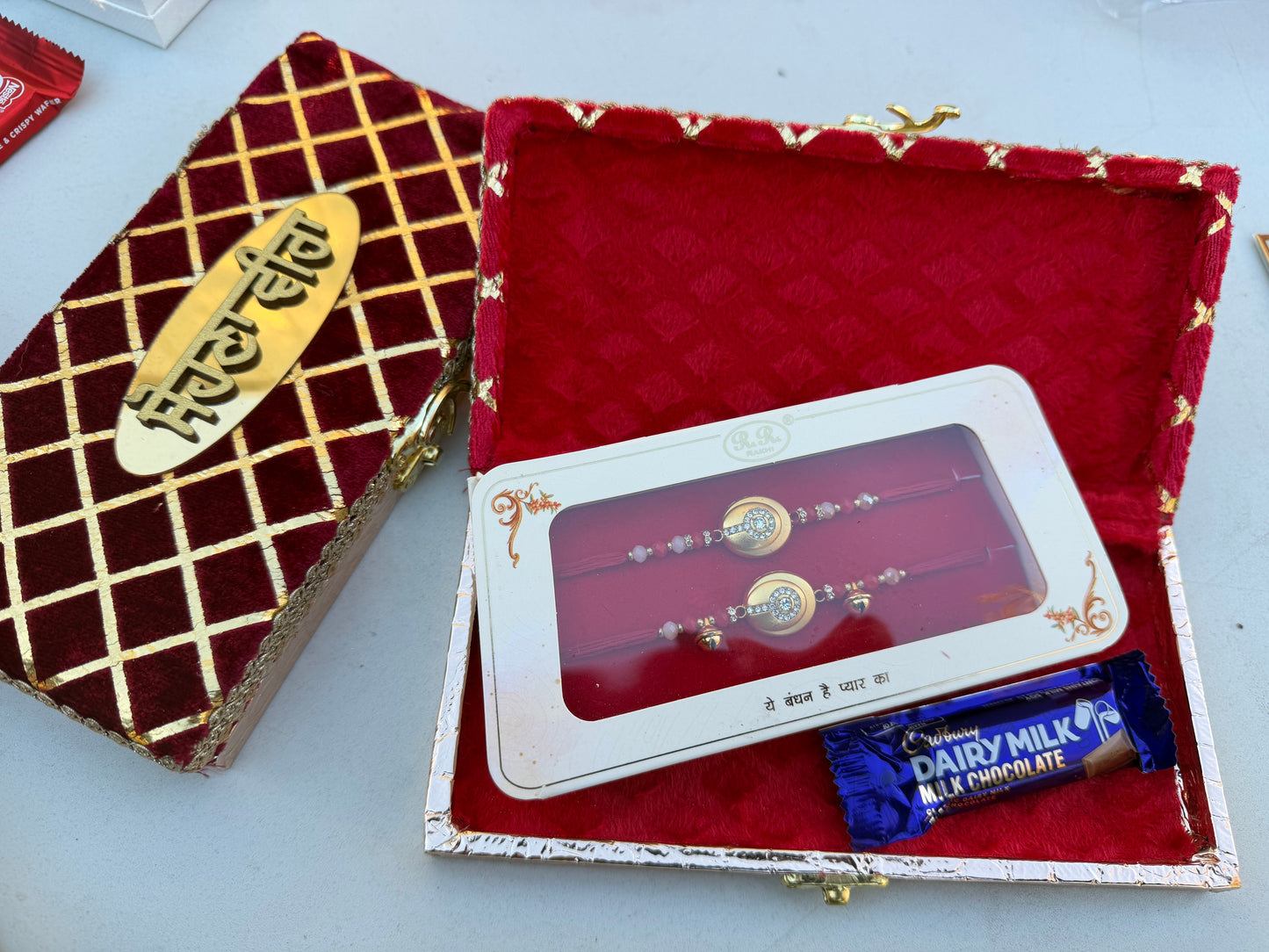 Rakhi hamper box for bro- bhabi (includes assorted combo rakhi + 1 choclate )