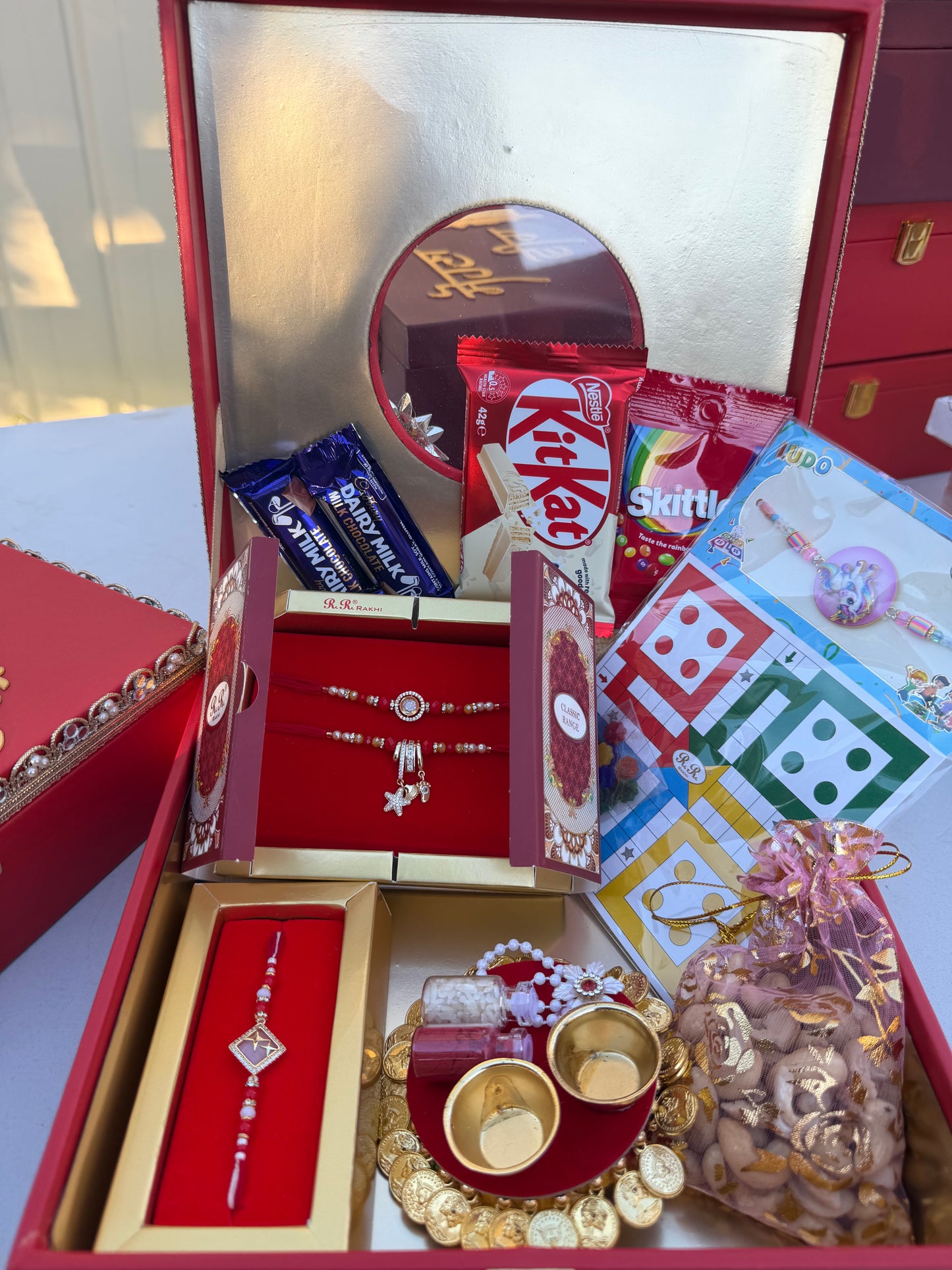 Family Rakhi Hamper (includes Combo rakhi , Single rakhi , Kids Rakhi , Kumkum-rice tray , nuts , chocolates & skittles