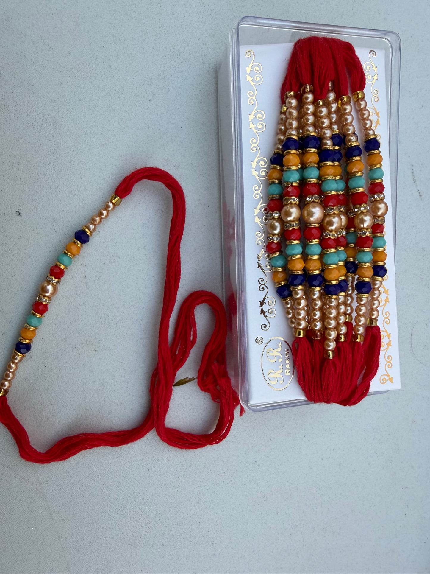 Multicoloured pearl rakhi thread (per pc)